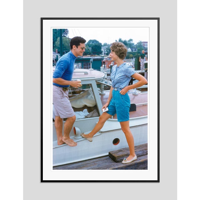 A Couple At The Regatta by Toni Frissell A couple conversate by the side of a yacht during the Harvard-Yale Regatta, circa...
