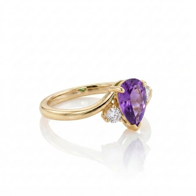 Exude royal elegance with this beautifully tailored pear-cut amethyst bypass ring. Showcasing a deep, velvet-purple...