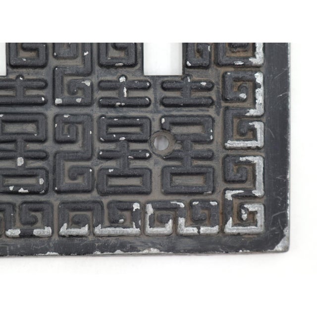 Vintage black painted zinc alloy three gang light switch wall plate cover with a Greek key pattern. The original mounting...
