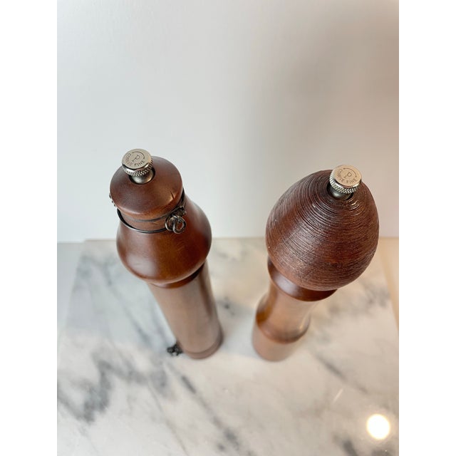 A unique set of sculpted hardwood salt and pepper grinders. These tall grinders have unique softly turned shaping in rich,...