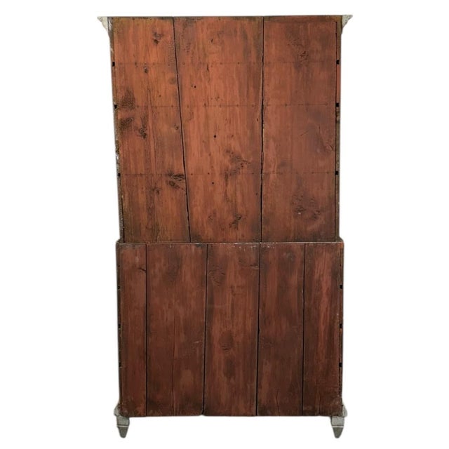 A stately and beautifully preserved Swedish cupboard secretary dating from 1810 to 1830, crafted in oak and pine with a...