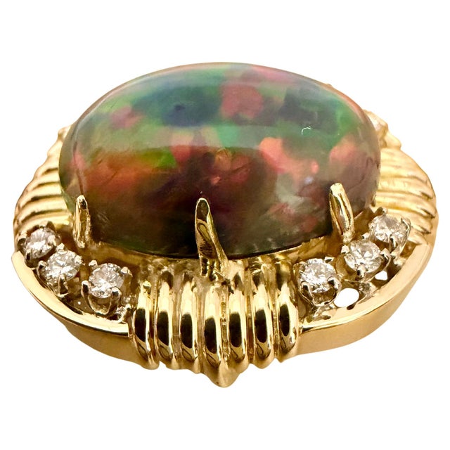 Approximately 10 Ct Oval Shape Black Australian Opal Cocktail Ring 14 Kt Yellow Gold, SIZE 6.5 Introducing our captivating...