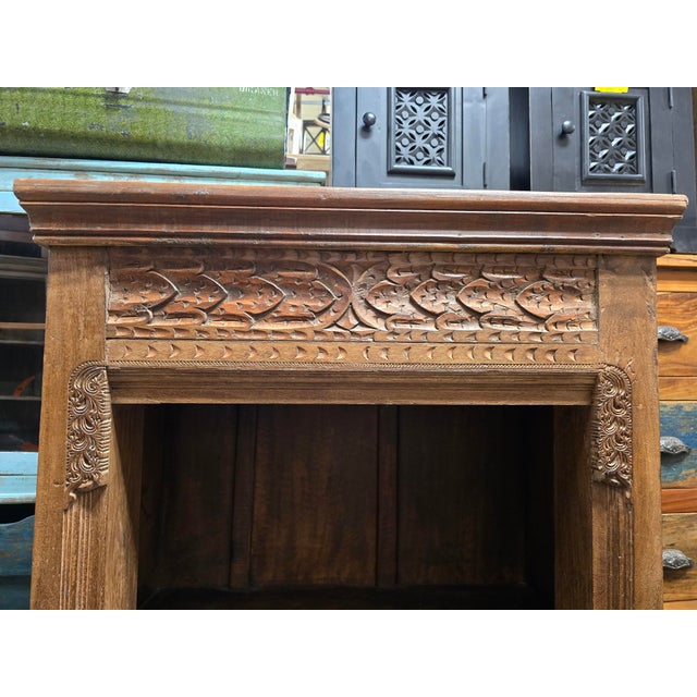 Bring global warmth and artisanal character to your space with this striking vintage solid wood bookcase. Featuring a...