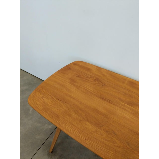 Authentic vintage plank dining table. Model 382 by Ercol (unmarked). Solid elm wood top and beech wood legs. This piece is...