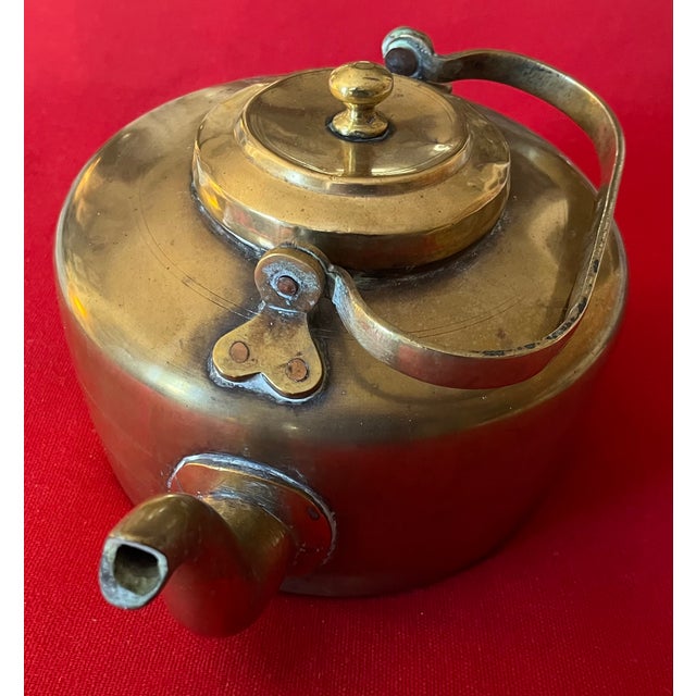 Antique 19th century English colonial brass tea kettle with swing handle. Heavy gauge construction. Measures 12 across...