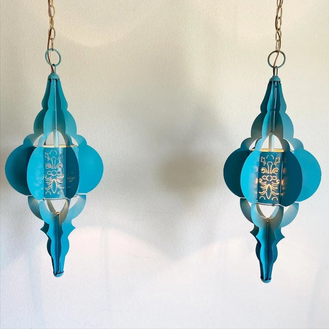 Gorgeous pair of large blue enameled Moroccan-style pierced metal pendant lights with elongated frames, rounded fins, and...