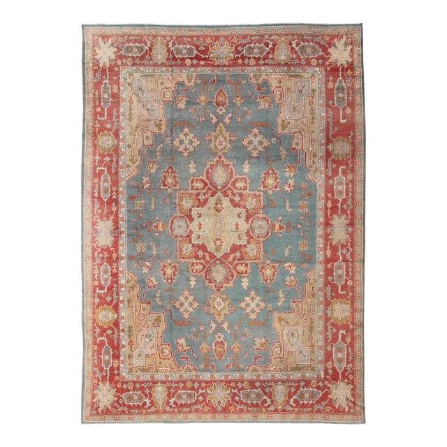 Antique Turkish Oushak Rug on a Blue Background and Orange-Red Color Border For Sale