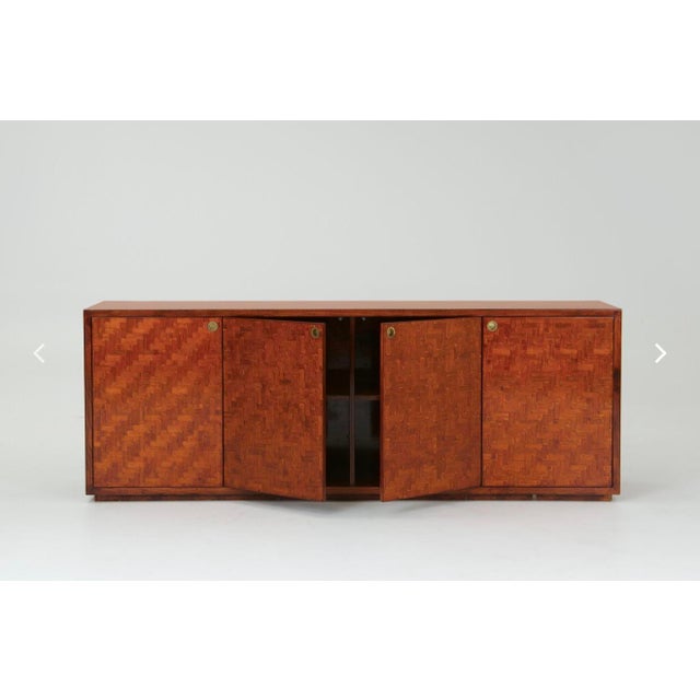 A sideboard in pressed bamboo, presumably made in Italy in the 1970s. The sideboard opens up to shelves on the left and in...