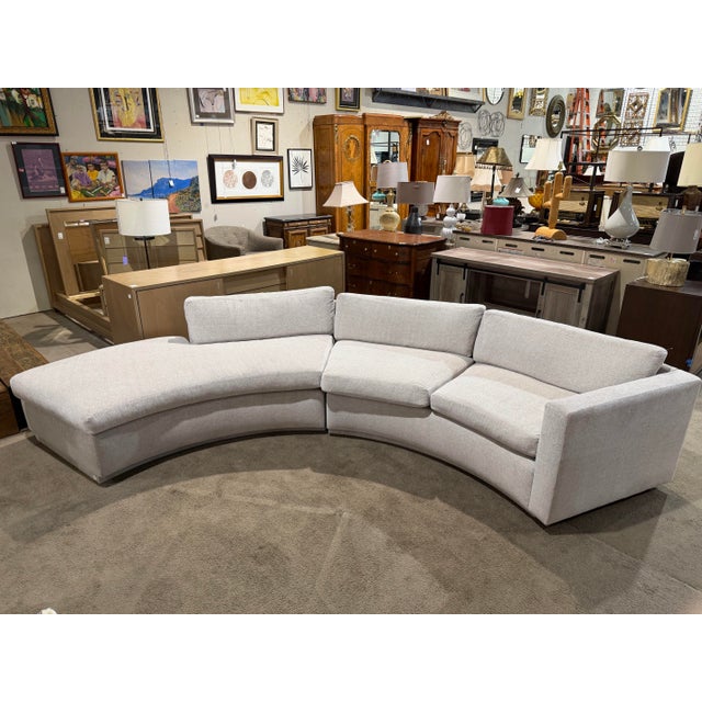 Sleek, architectural, and unmistakably modern, this Nathan Anthony curved sofa makes a striking statement with its...