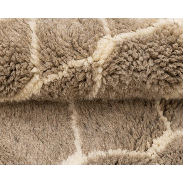 Exquisite hand-knotted wool rug with a detailed honeycomb design in Taupe and Misty Taupe, intersected by vertical Ivory...