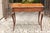 A French Louis XV style oak side table with single drawer, scalloped apron and cabriole legs from the early 19th century....