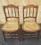 A Pair of Victorian Walnut and Cane Seat Spindle Back Side Chairs with newer caning. Measures 16.5" in width, 18" in depth...