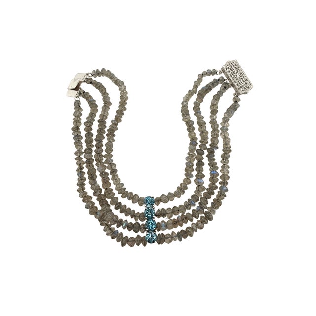 A fine vintage four strand labradorite beaded bracelet. The bracelet has four prong set sparkling blue topaz serving as a...