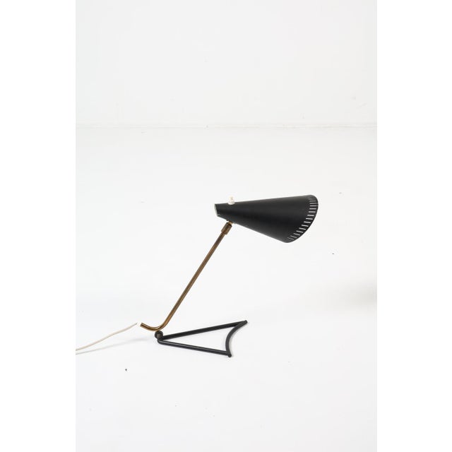 This 1950's Danish iconic metal table lamp was designed by Svend Aage Holm Sorensen. Holm-Sørensen is best known for the...