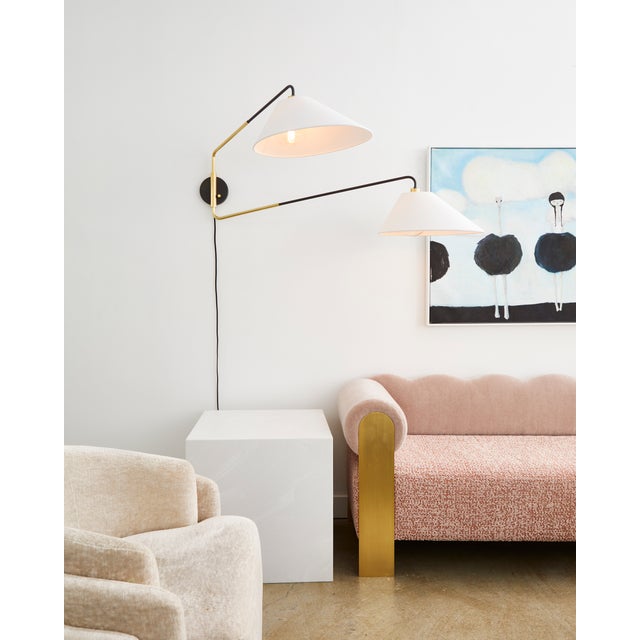 Duo is full of singular style. Elongated shades in white Belgian linen spread out from curved arms of aged old bronze. The...