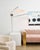 Duo is full of singular style. Elongated shades in white Belgian linen spread out from curved arms of aged old bronze. The...