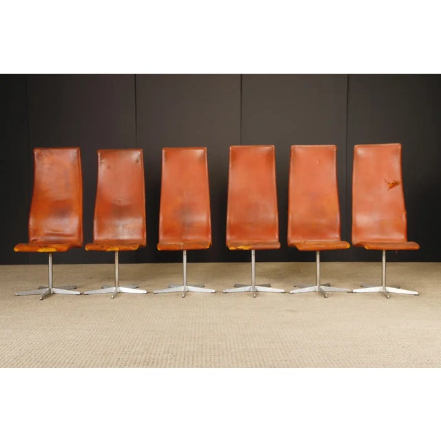 A highly collectible set of six early production Oxford high-back swivel chairs designed by Arne Jacobsen and produced by...