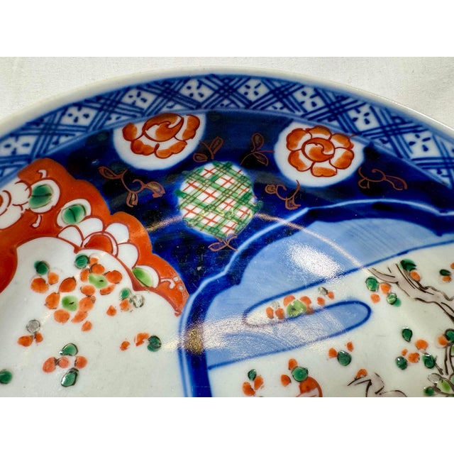 Ceramic Antique Shallow Porcelain Imari Bowl Adorned With Crane Birds, Butterflies & Delicate Floral Designs - From Japan - Circa 1920 For Sale - Image 7 of 12