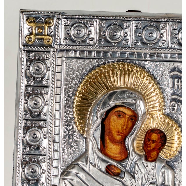 Italian silver repoussé icon of the Virgin Mary (Theotokos) holding the Christ Child, with an ornate quatrefoil-clasp...