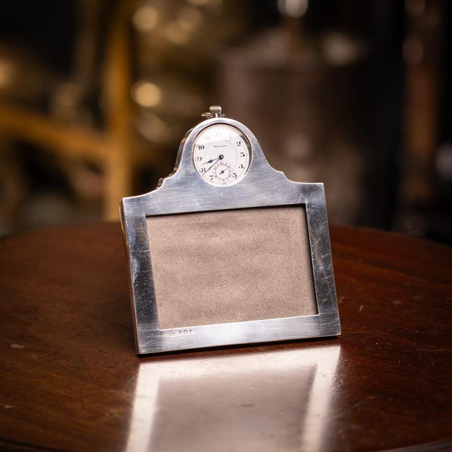 Antique 20th century english solid silver photograph frame. Of rectangular form with a built in mounted clock on the top....