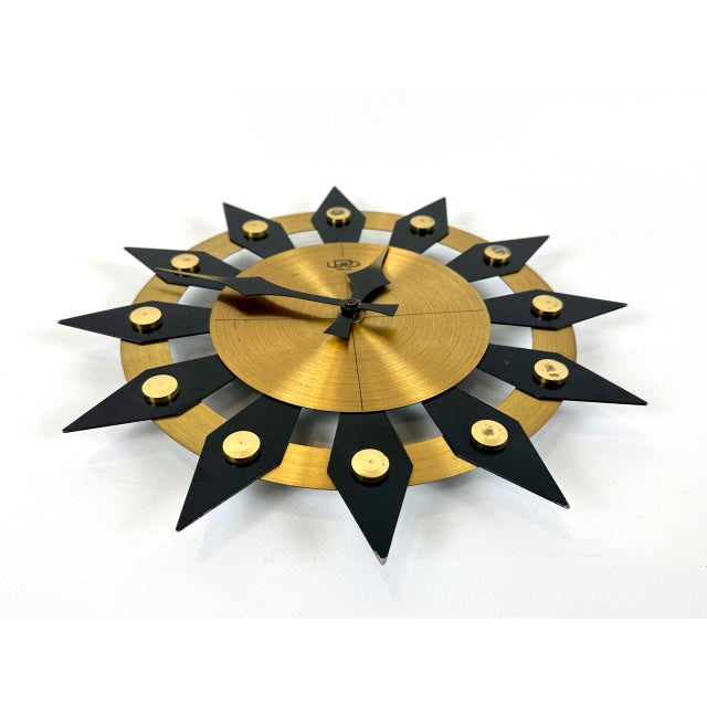German Brass Sunburst Wall Clock from UPG Halle, 1970s, in Very Good conditions. Designed 1970 to 1979 This piece has an...