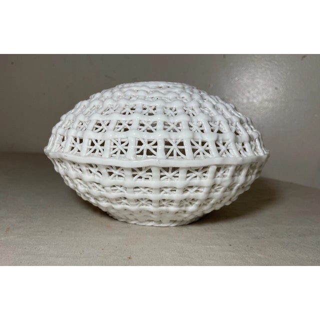 This exquisite antique Chinese white basket weave vase is a testament to the timeless artistry of porcelain and pottery....