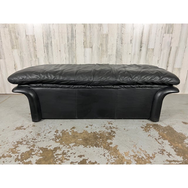 Post Modern black leather bench with curved handle ends.