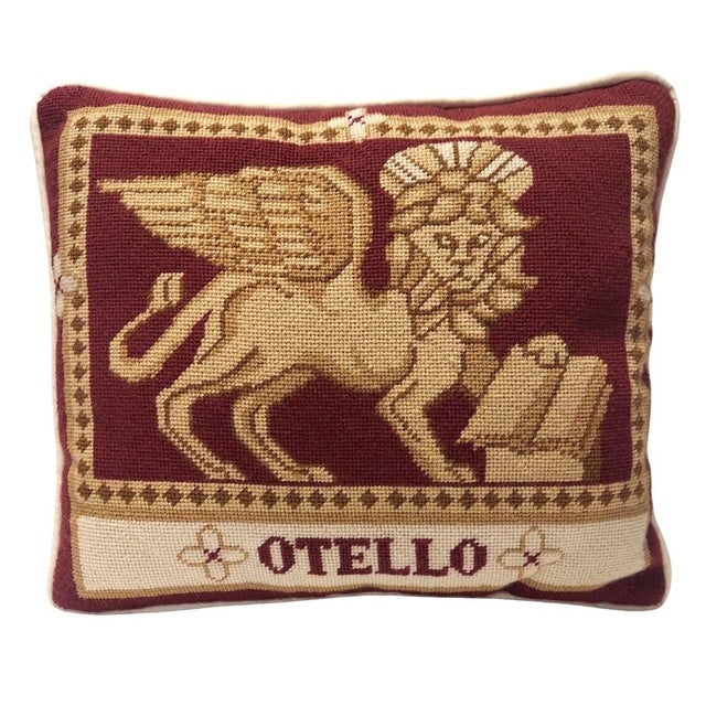 Lion/sphinx on a burgundy background. Otello. Needlepoint. Possibly handcrafted. The fabric on the back of the pillow is a...