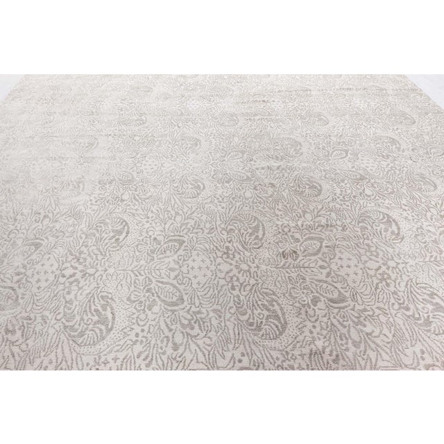 This elegant hand-knotted rug, sized 10′0″ × 12′0″ (304 × 365 cm), gracefully melds Persian roots with modern sensibility....