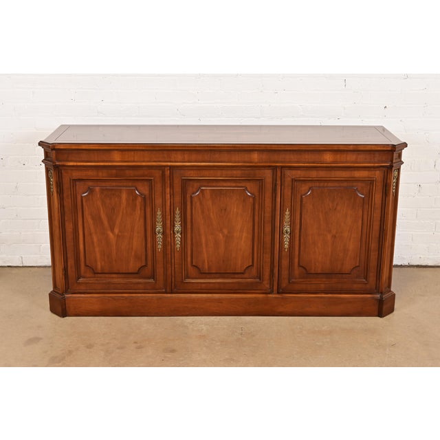 A gorgeous mid-century French Regency Louis XVI style sideboard, credenza, or bar cabinet By Baker Furniture USA, Circa...