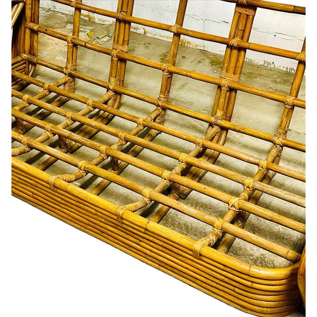 A 1950's six-strand bamboo three-seat sofa in the style of Paul Frankl. The sofa embraces the mid-Century tropical style...