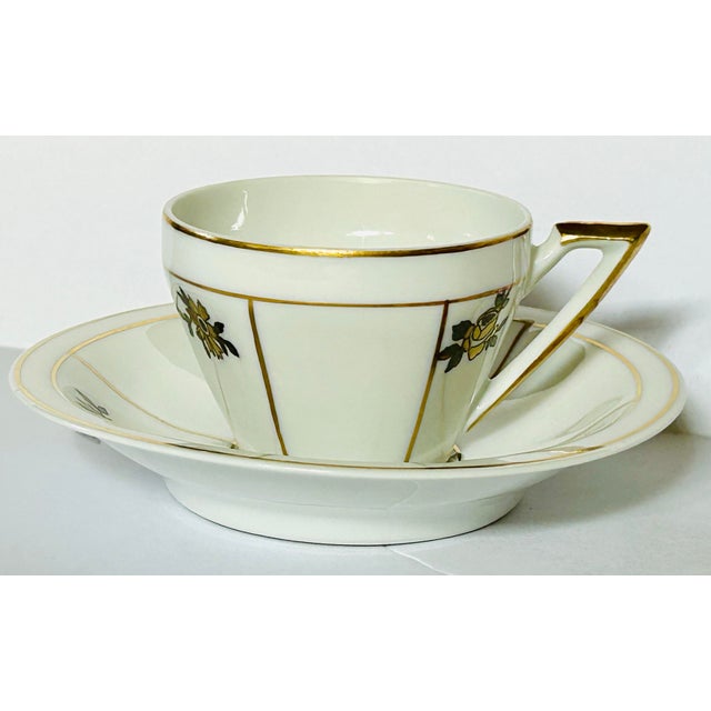 This is a beautifully designed set of 8 espresso cups and saucers from Portugal each with hand painted minimal gold lines...