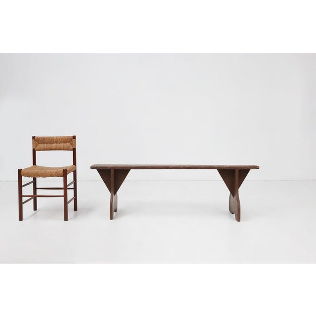 France / 1890 / bench / wood / rustic / mid-century / French provance A rustic wooden bench with brown paint and beautiful...