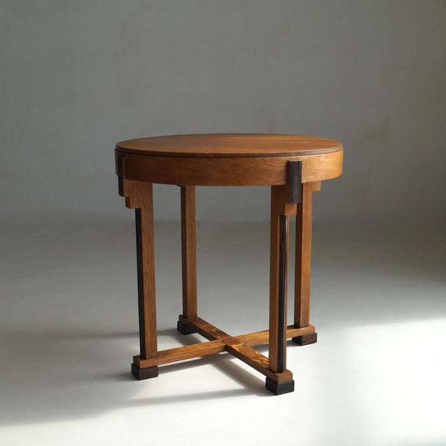 A Dutch Art Deco side table with a strong geometry and architectural presence. Dating to the 1920s, executed in solid oak,...