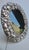 Large oval format frame with a border of textured flowers and fruits. Elaborate design in relief. No maker's marks are...
