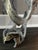 Modern pendant/lamp with a silver and white finish, visible bulb socket, and cord. Handmade cast metal design with a...