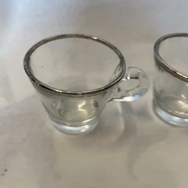 This is a beautiful pair of Dorothy Thorpe glass and silver rimmed espresso cups. These would look great out on your...