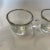 This is a beautiful pair of Dorothy Thorpe glass and silver rimmed espresso cups. These would look great out on your...