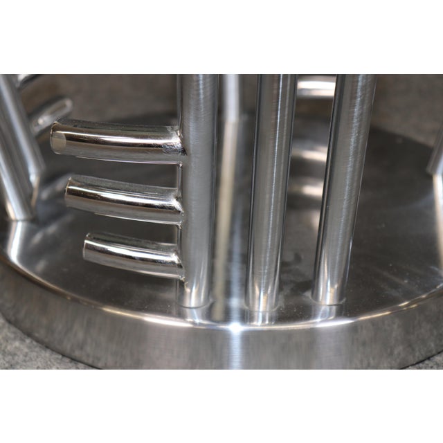 This striking pair of modern chrome and glass end tables showcases sleek contemporary design with a bold architectural...