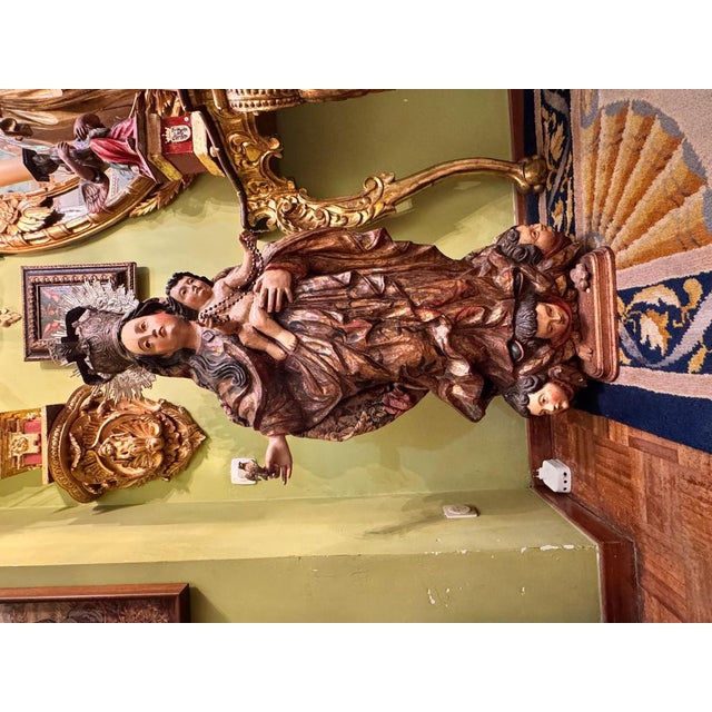 A magnificent Baroque sculpture carved in wood and polychromed, depicting the Virgin and Child. The Virgin is crowned with...