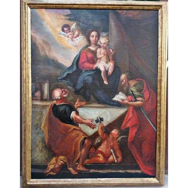 Beautiful oil on canvas depicting the Madonna and Child enthroned, and Saints Peter and Paul depicted in contemplation...