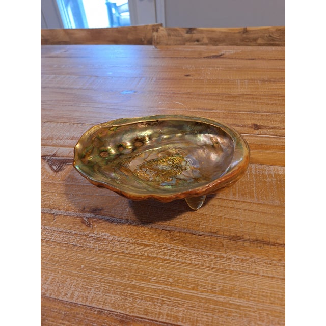 1960s Abalone shell trinket dish with Lucite feet. 7.5x6x3.5 inches. gold iridescent finish inside.