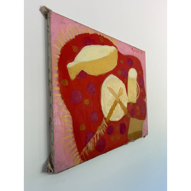 This is a whimsical and vibrant midcentury still life painting with plate and mug signed in the upper right corner “April...