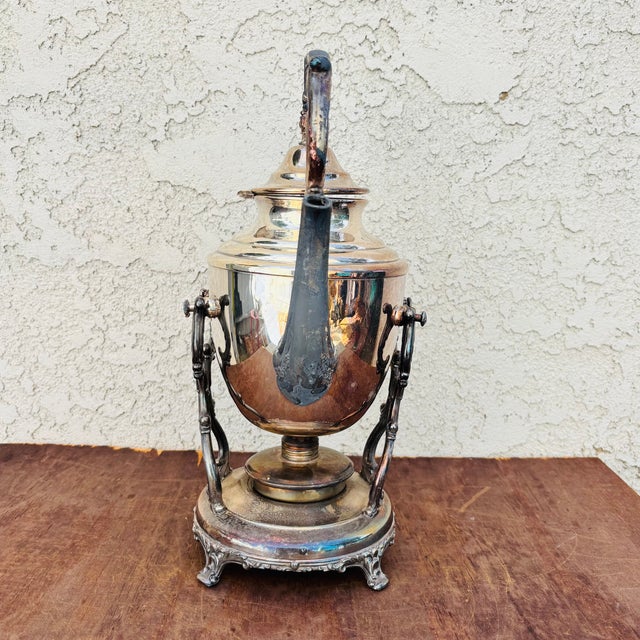 This is a beautiful antique American silver plated hot-water/spirit kettle/ teapot on an ornate raised stand with...