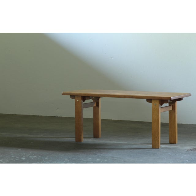 A solid oak coffee table made by an unknown carpenter in the 1960s or 1970s. This is the kind of piece that carries the...