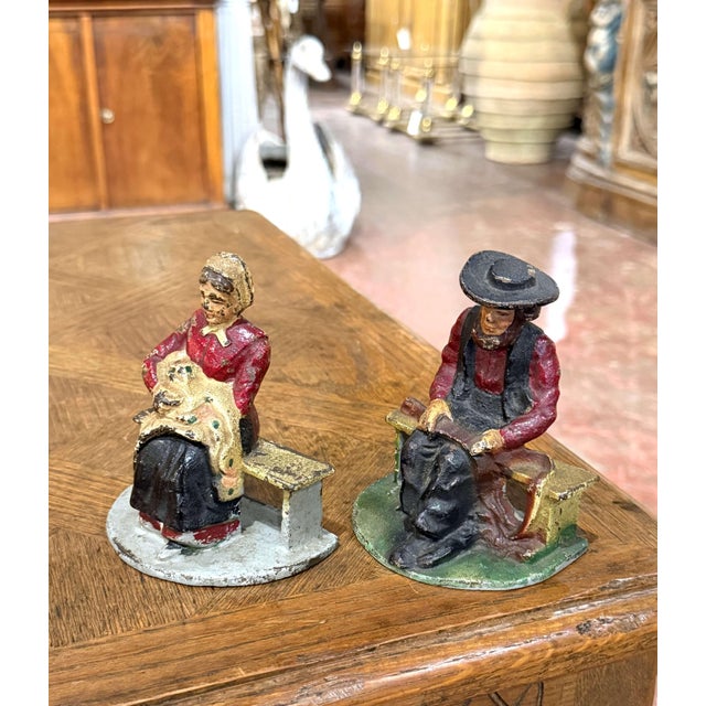 Charming and full of character, this pair of antique cast iron bookends features two seated figures dressed in traditional...