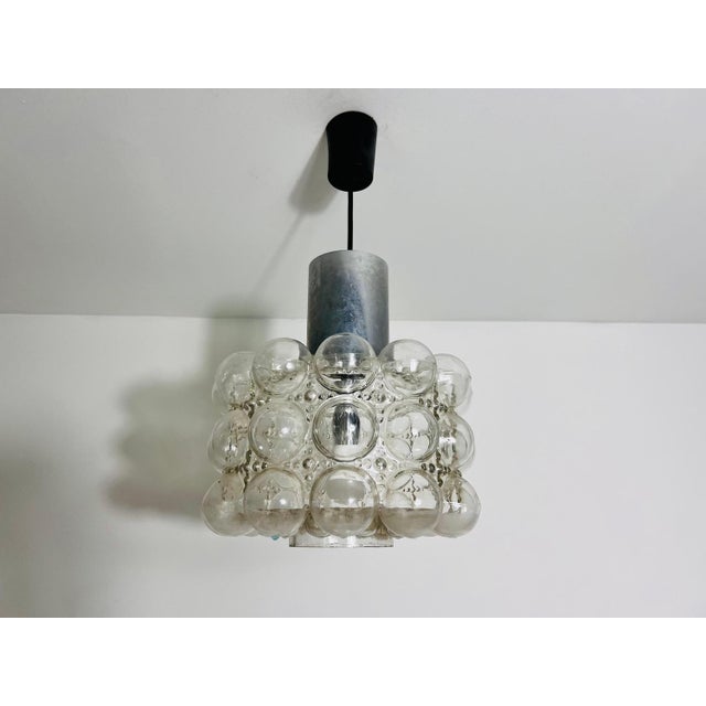 A bubble glass hanging lamp by helena tynell for limburg made in germany in the 1960s. Helena tynell is a glass and...
