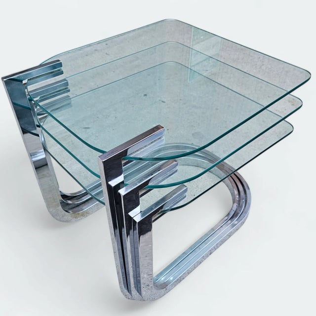 Featured is a set of Mid-Century Modern Design Institute of America Chrome and Glass Nesting They possess a sleek and...