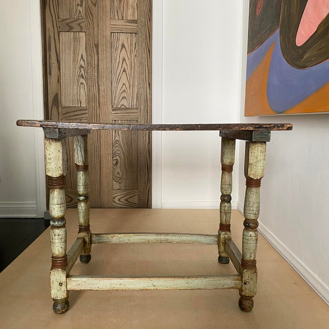 French Provincial Side Table the top with geometric design on turned legs.