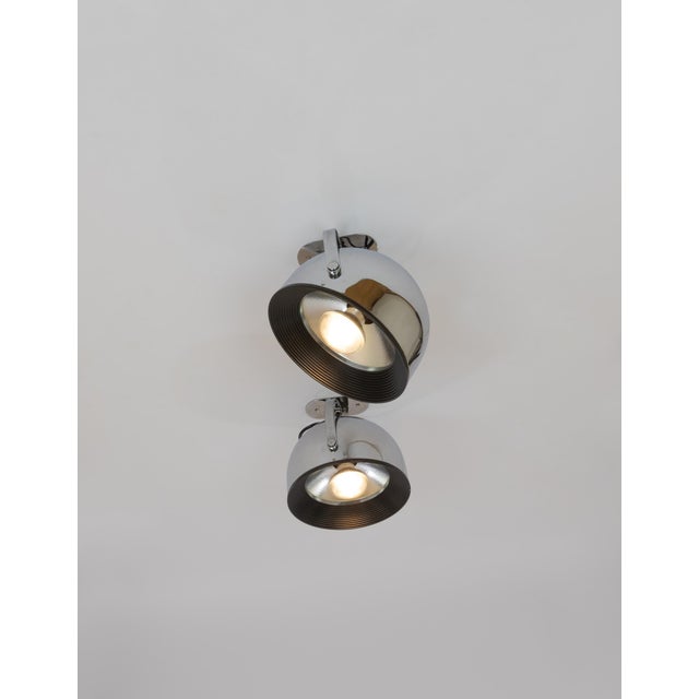 Pair of swiveling wall spots in chromed metal with silver coloured reflectors designed by Gae Aulenti and Livio...